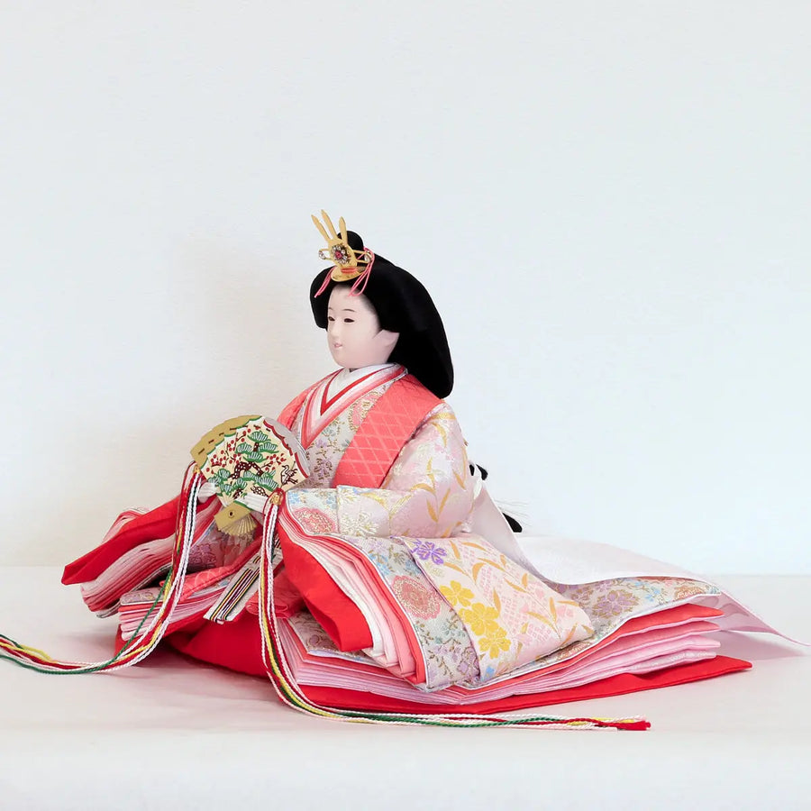A pink, spring-like, cherished three-tiered Hina doll display